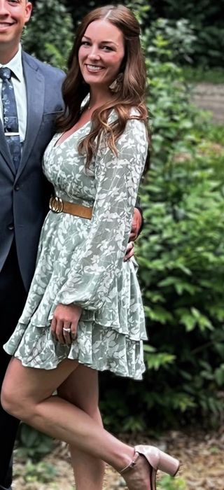A reviewer modeling the green dress