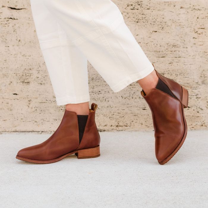 A model showcasing the boots in a rich brown color.