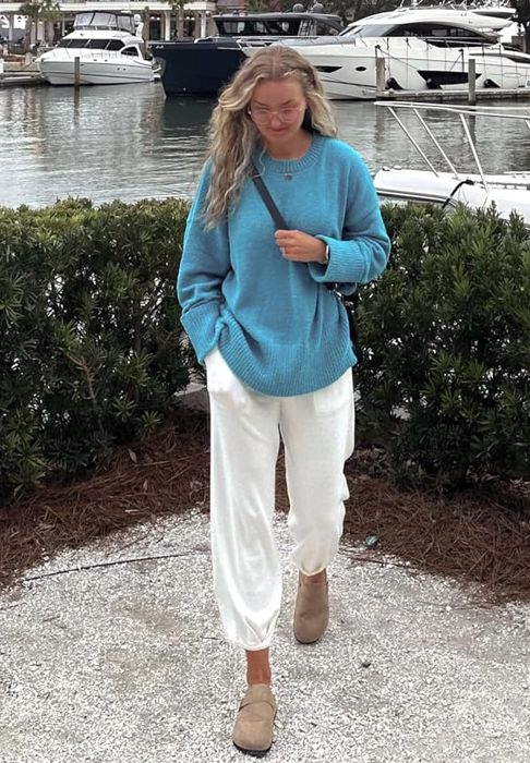 A reviewer modeling the lake blue sweater