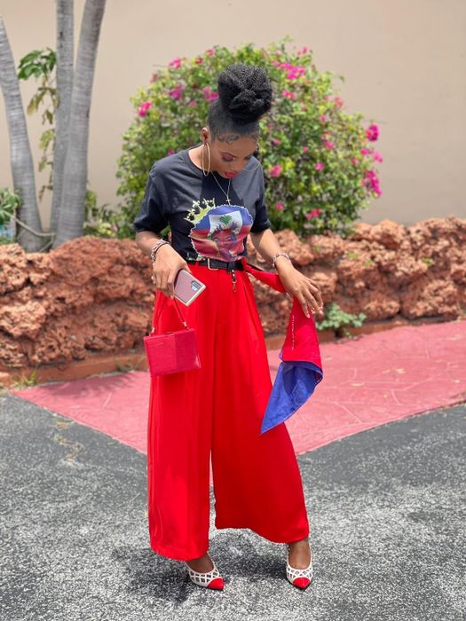 A reviewer showcasing the fiery red pants