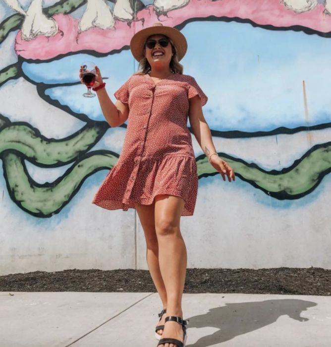 A reviewer modeling the red dress