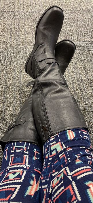 A reviewer wearing black boots