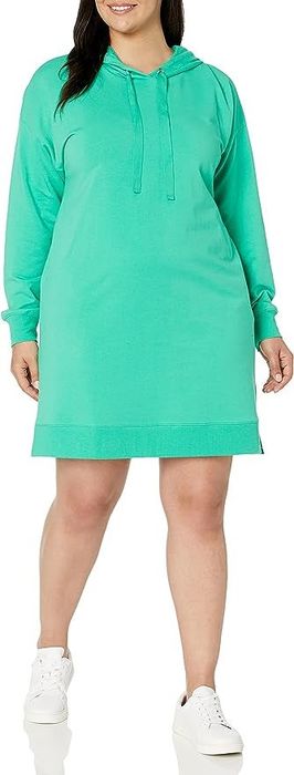model wearing a green dress that ends above the knee