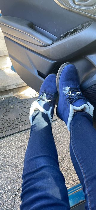 A reviewer shows themselves wearing the boots in blue.