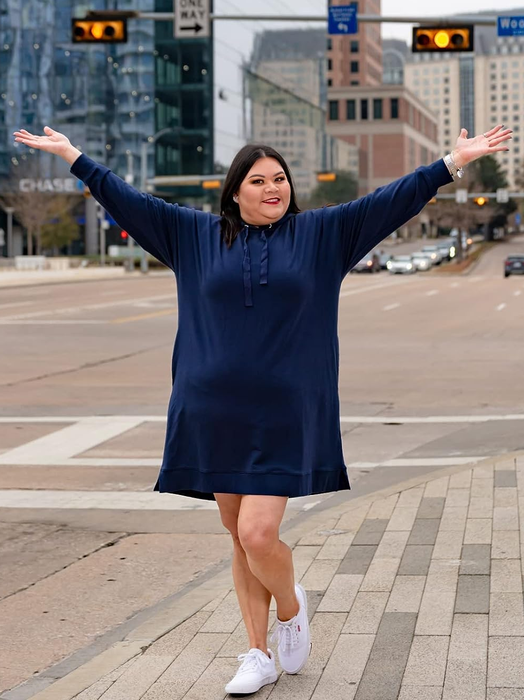 reviewer showcasing the navy version of the dress
