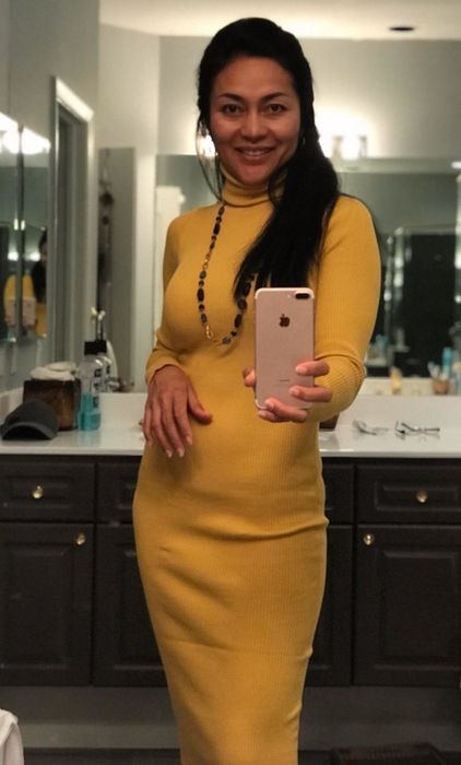A reviewer modeling the knee-length yellow dress