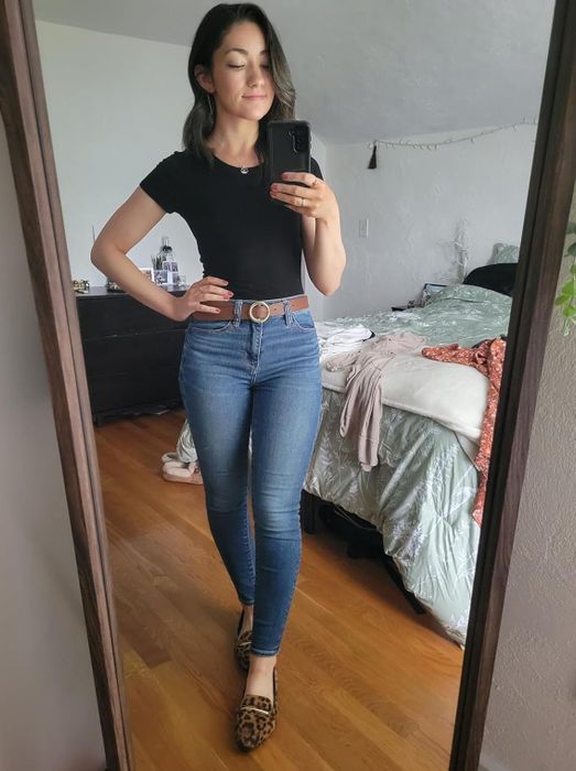 A reviewer showcasing the leopard print flats