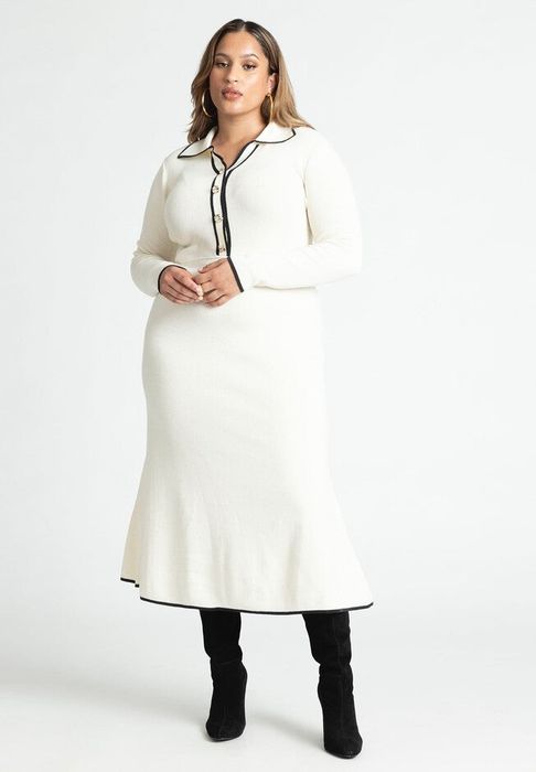 model wearing the white version with black piping