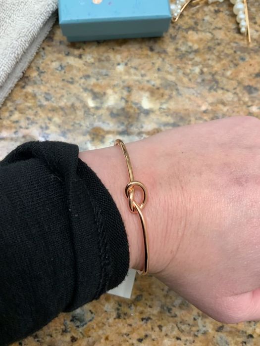 A reviewer wearing the rose bracelet