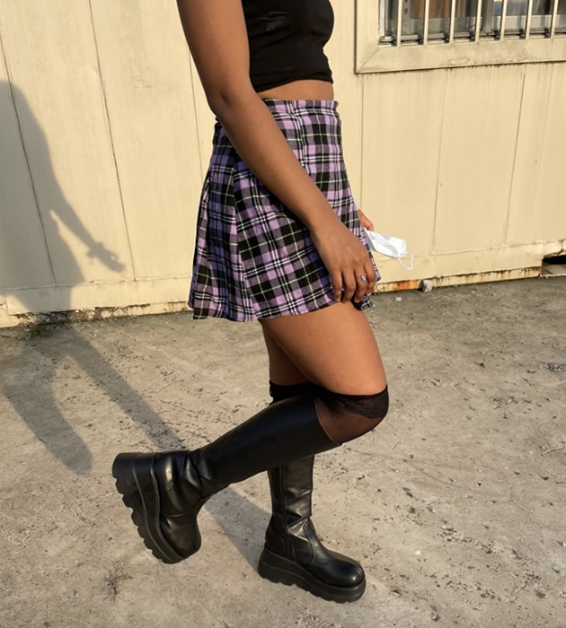 A reviewer rocking the black platform boots, showcasing their bold style.