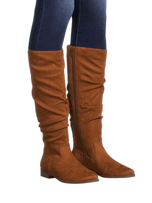 Knee-high boots with a low heel and a slouched design, styled with fitted jeans. Ideal for fall fashion outings
