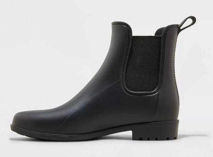 A black ankle boot featuring elastic side panels and a pull loop for easy wear