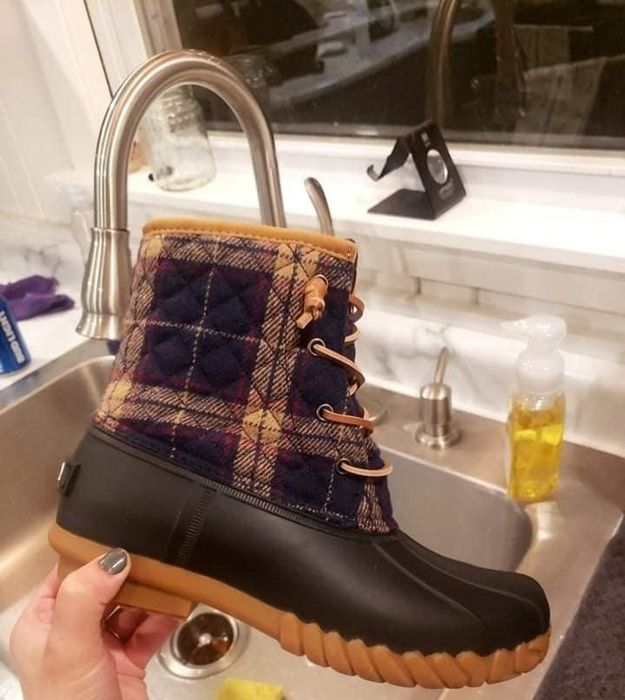 Reviewer holding a duck boot.
