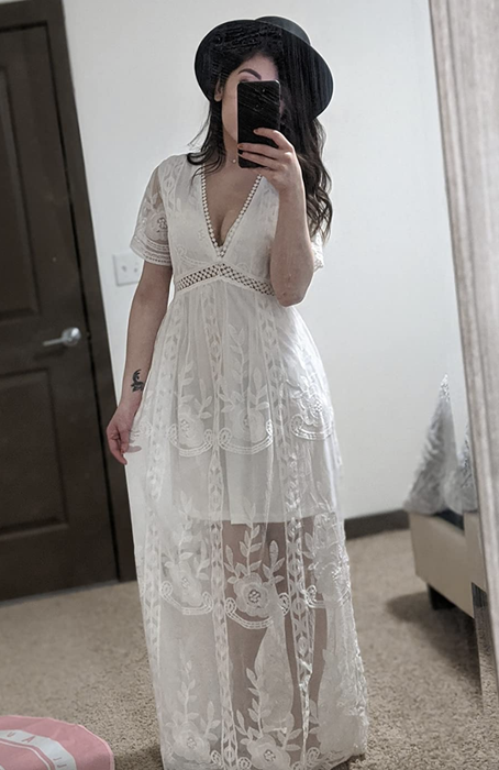 A reviewer wearing the elegant lace V-neck dress.
