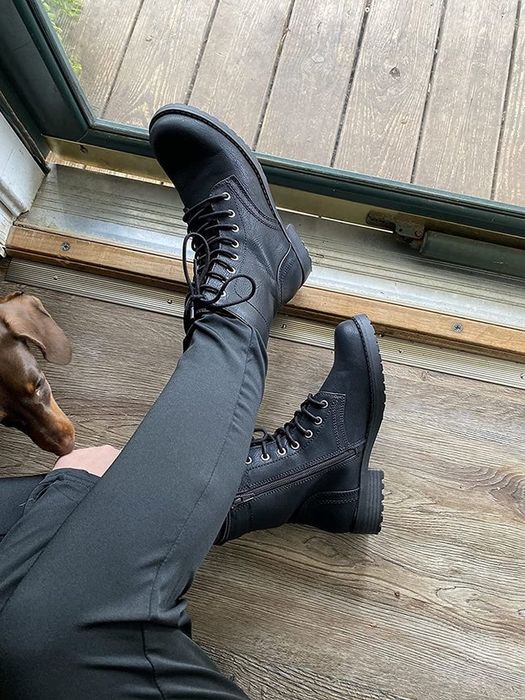 A reviewer wearing black boots