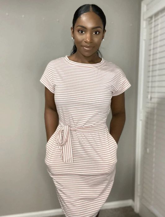 A reviewer modeling the striped dress