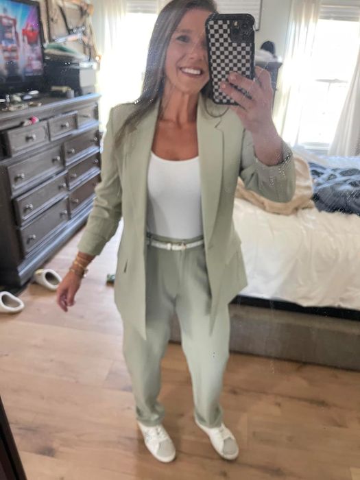 reviewer wearing a light green single-button blazer paired with coordinating trousers