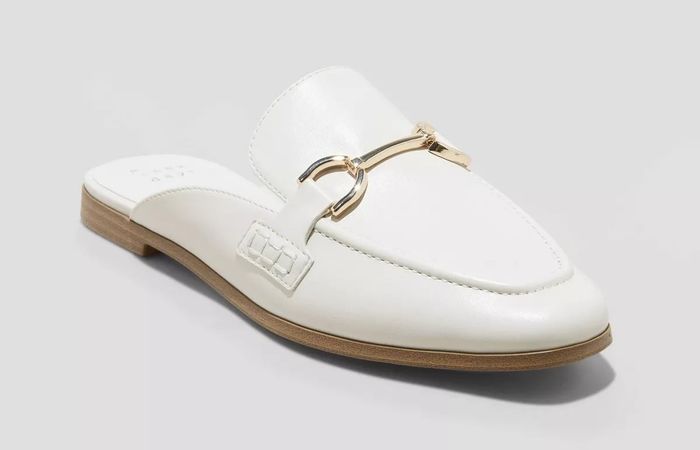 A chic white leather loafer featuring a gold buckle detail and a low wooden heel, ideal for both casual and semi-formal outfits