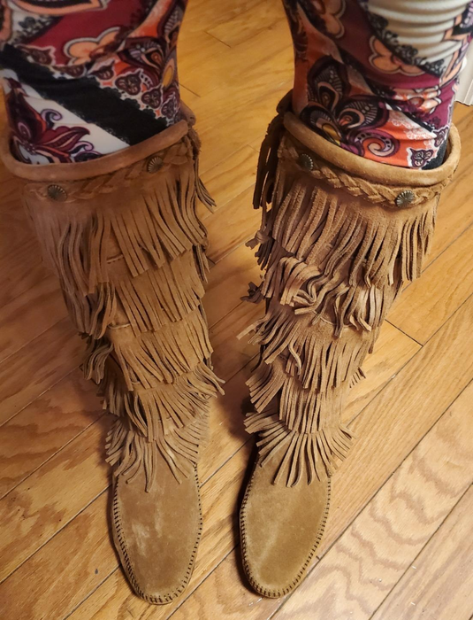 A close-up shot of fringed suede boots, capturing their detailed texture.