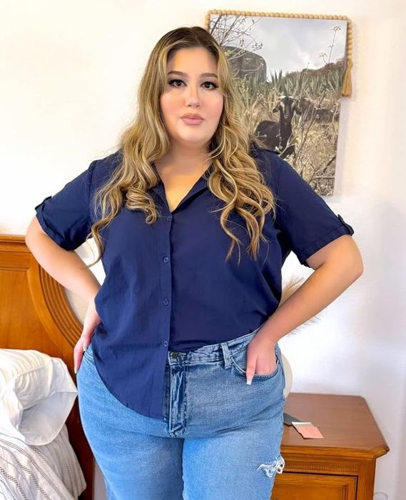 A reviewer showcasing the navy blouse