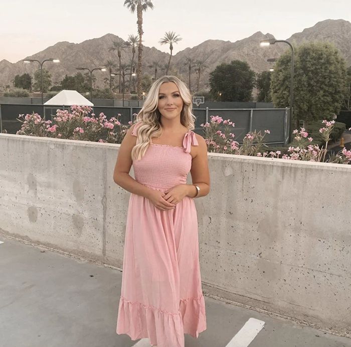A reviewer modeling the pink dress