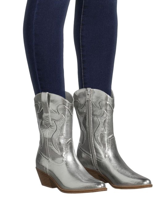 Silver cowboy ankle boots with pointed toes and wooden heels, paired with dark skinny jeans
