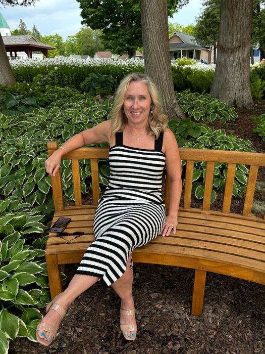 A reviewer wearing the black and white dress