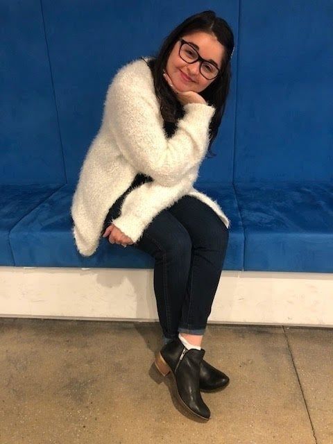 Mytour editor, Heather Braga showcasing the black boots with a brown heel