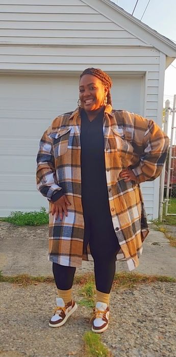 A reviewer wearing the orange plaid coat