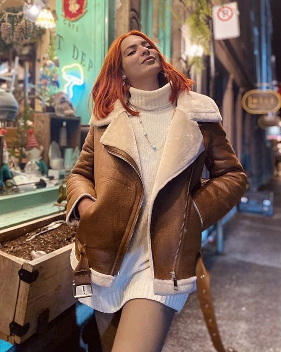 a reviewer modeling the brown jacket