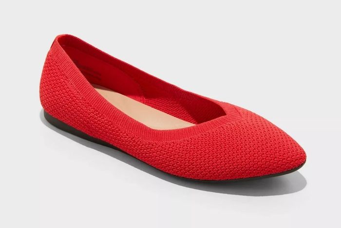 A single red ballet flat with a woven texture, displayed on a plain background