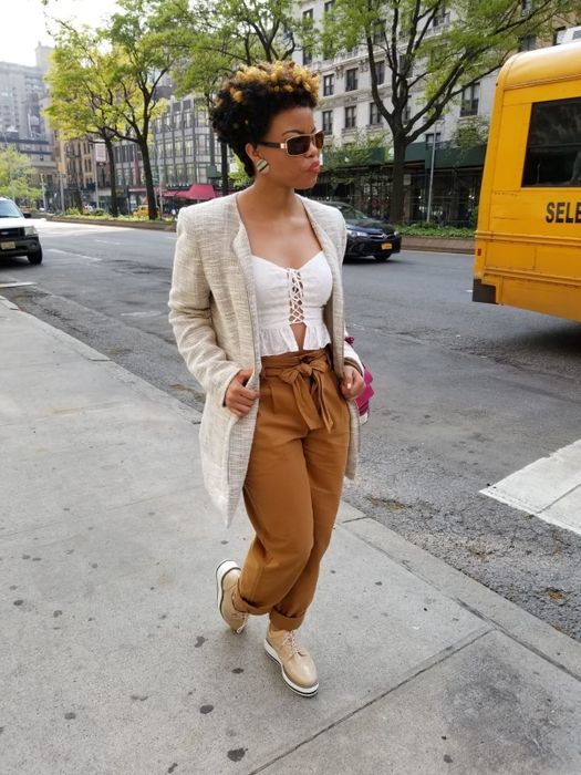 A reviewer wearing apricot platform oxfords with mustard tie-waist pants, a cami, and a white blazer