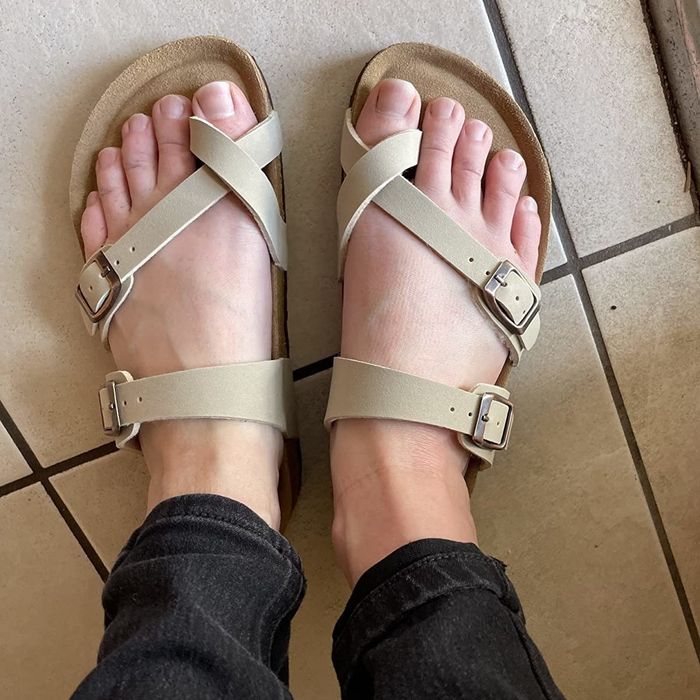 a pair of sandals on a reviewer's feet
