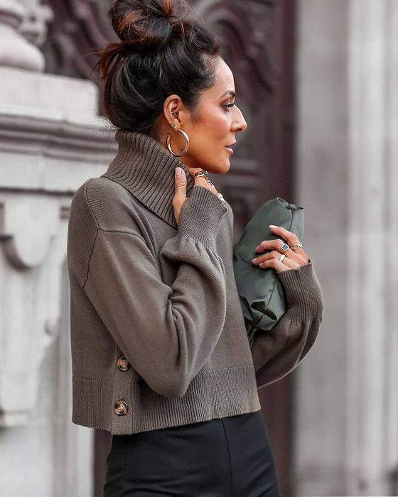 Side view of a model wearing the olive green turtleneck, showcasing the side buttons