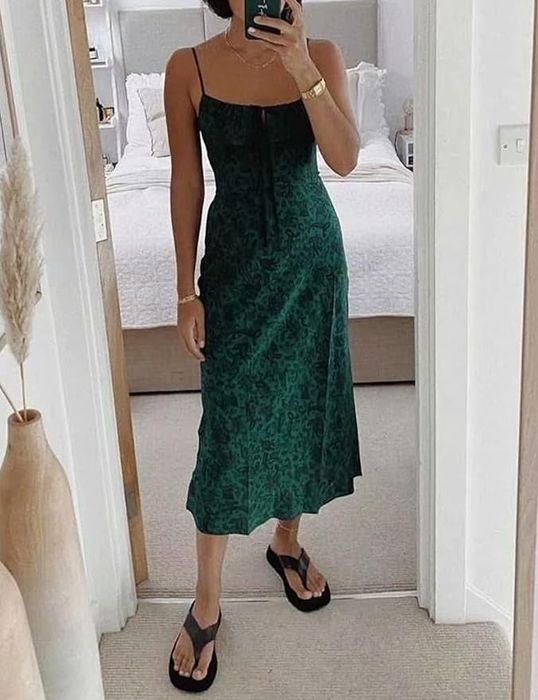 A model wearing a green and black printed '90s-style maxi strappy tank dress.