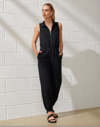 A person wearing a black zip-up jumpsuit.