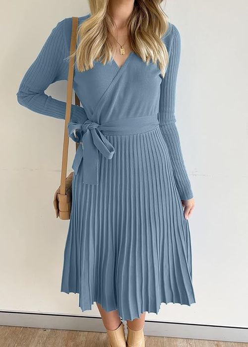 A model wearing a pleated wrap dress with long sleeves and a tie waist.