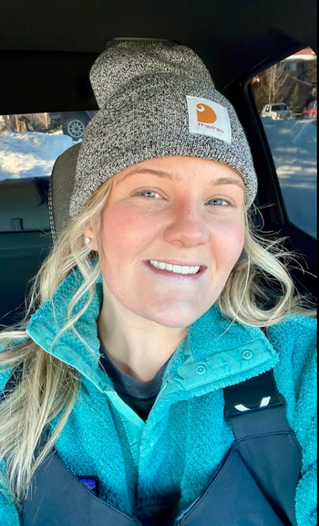 A reviewer wearing a gray marled beanie.