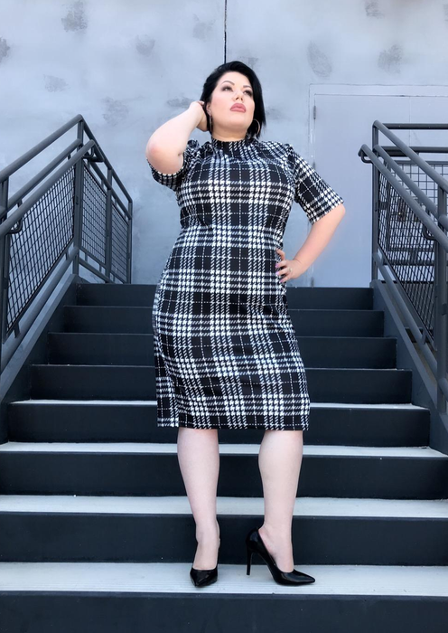 reviewer wearing the black and white gingham bodycon dress