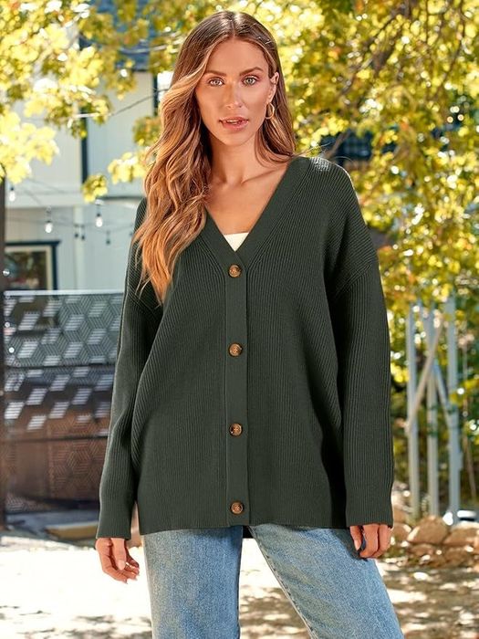 A woman outdoors dressed in a ribbed button-up cardigan paired with jeans.