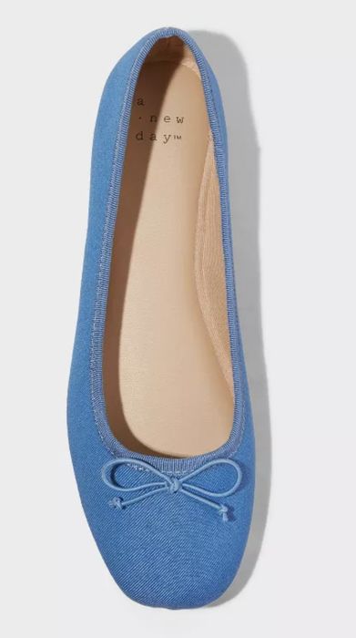Blue flat shoe with a cute bow on the toe