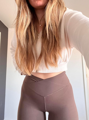 A reviewer wearing the brown version of the leggings.