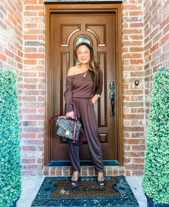 reviewer wearing the brown jumpsuit