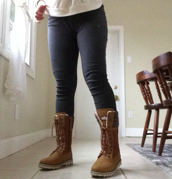 A reviewer rocking these boots with black leggings.