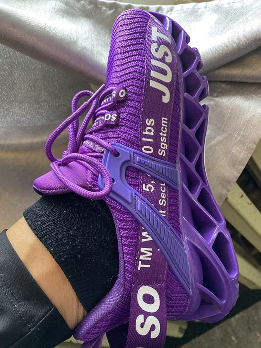 A reviewer wearing purple sneakers.