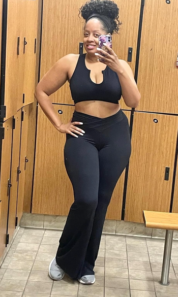 A reviewer posing in black yoga pants.