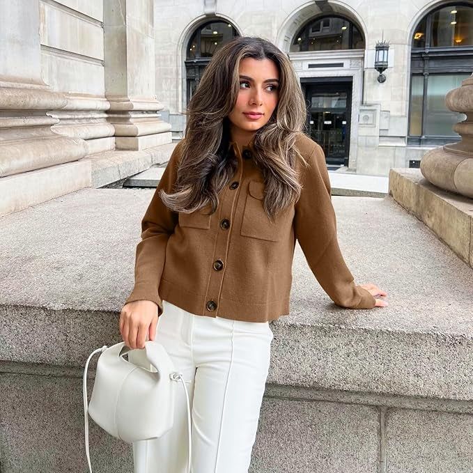 A model wearing a brown button-up jacket and white pants.