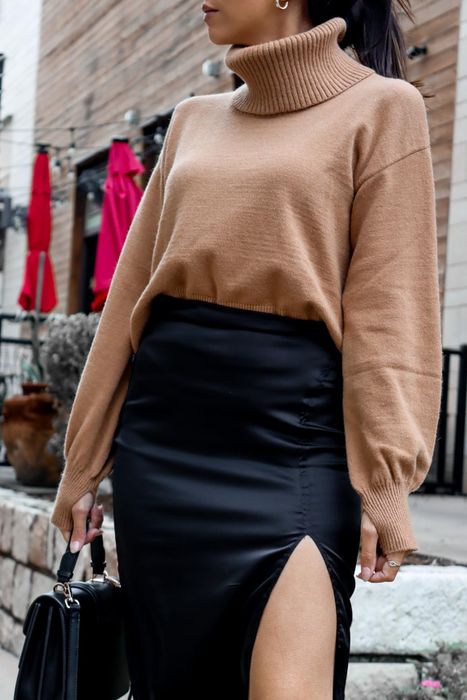 reviewer styling the praline turtleneck with a black skirt