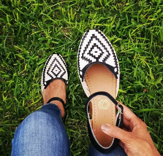 Black and white ankle-strap woven shoes featuring a diamond pattern across the top.