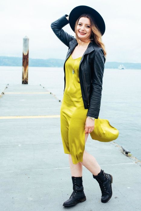 reviewer styling the chartreuse dress with a leather jacket and boots